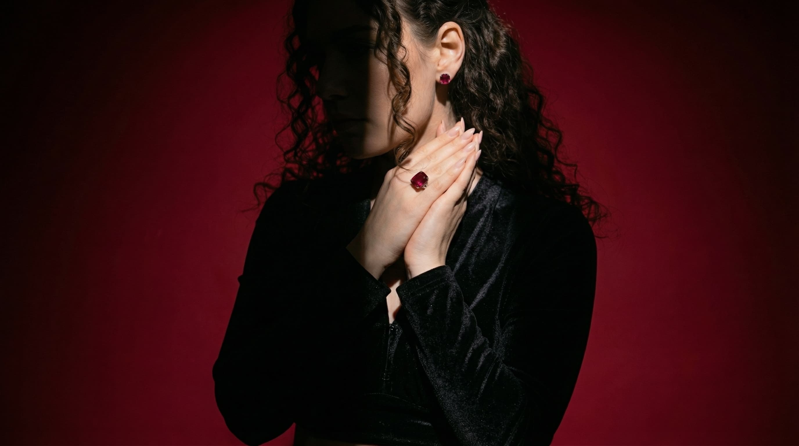 Elegant model wearing pearl earring against dark starry backdrop