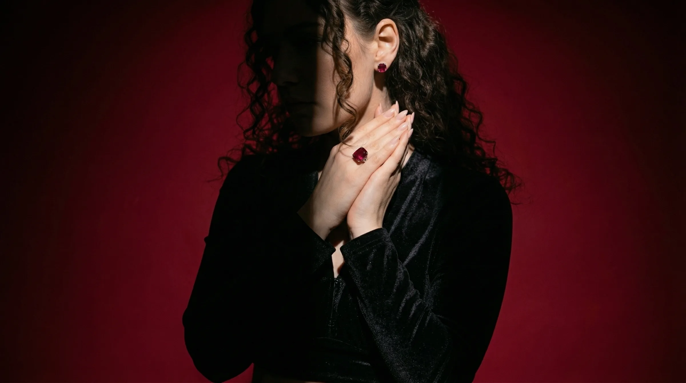 Elegant model wearing pearl earring against dark starry backdrop